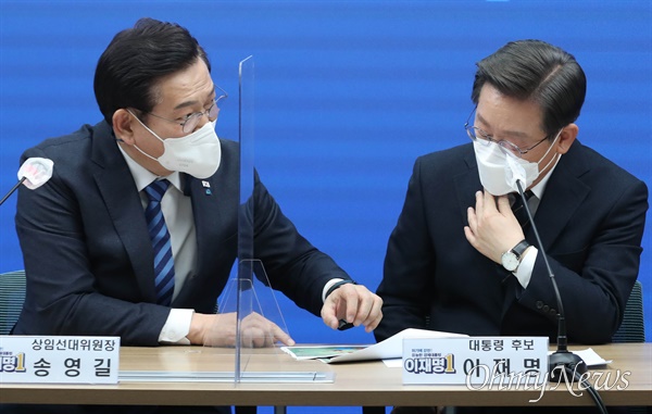 더불어민주당 송영길 대표와 이재명 대선 후보가 2월 24일 긴급 안보경제 연석회의에서 대화하고 있다.