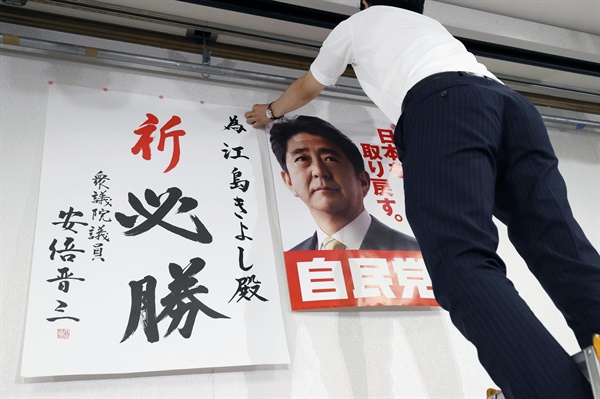 일본 참의원 선거 투표일인 10일 오후 야마구치현 야마구치시에 있는 에지마 기요시 자민당 후보의 진영에서 관계자가 아베 신조 전 일본 총리의 사진이 담긴 자민당 홍보물을 벽에 붙이고 있다.

야마구치현은 8일 유세 중 총격을 당해 목숨을 잃은 아베 전 총리의 선거구(지역구)였다. 