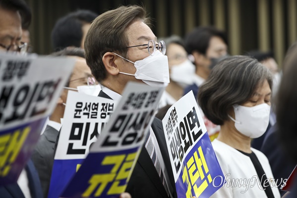  더불어민주당 이재명 의원이 11일 서울 여의도 국회에서 열린 의원총회에서 윤석열 정부를 비판하는 내용의 피켓을 들고 있다.