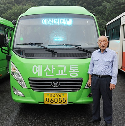 자신이 운전하는 소형버스 앞에서 운행을 준비하는 박환수씨.