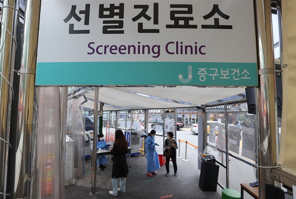 코로나19 신규 확진자가 전날보다 6091명 줄어든 2만8648명 발생한 6일 오전 서울 중구보건소에 마련된 선별진료소를 찾은 시민들이 안내를 받고 있다.