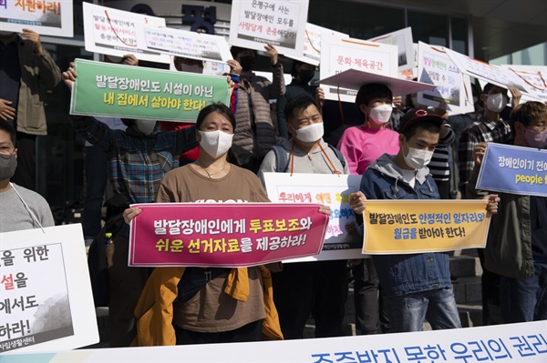  “발달장애인에게 투표보조와 쉬운 선거자료를 제공하라!”고 적힌 피켓을 든 모습 (사진 : 정민구 기자)