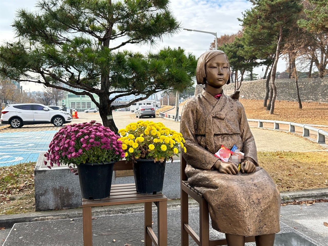 홍주읍성 인근 ‘홍성 평화의 소녀상’ 옆자리에는 자주색과 노란색 가을 국화가 놓여 있다.
