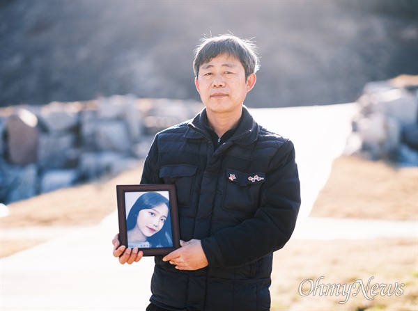 이태원 참사 희생자 김연희씨의 영정을 들고 있는 아버지 김상민씨.