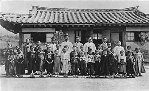 초창기 진명학교 교사들과 학생들의 단체사진. 1912년에 찍은 사진으로 뒷줄에 선 교사들 가운데 오른쪽에 서 있는 짧은 머리의 남자가 김구응 선생으로 추정된다. (사진 '틈새의시간' 제공)