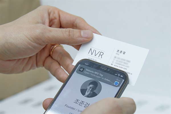 종이 명함을 스마트폰에 갖다 대면 명함의 정보가 저절로 스마트폰에 입력된다. NFC 태그를 종이에 삽입한 방식으로 제작한다. (사진은 조준걸 뉴버전 대표의 시연 모습)