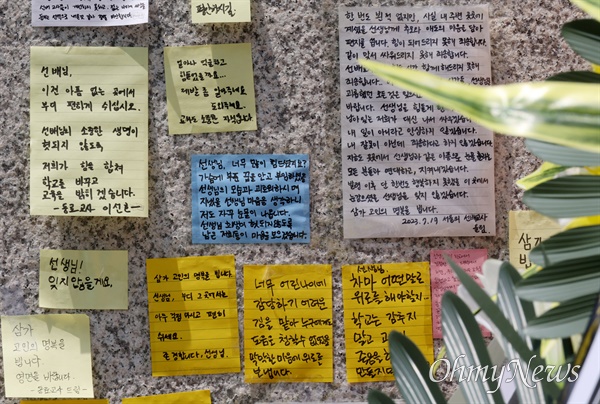 시민들이 20일 오전 서울 서초구 S초등학교 앞에서 1학년 교사의 극단적 선택에 가슴 아파하며 국화꽃과 위로의 메시지를 놓고 가고 있다.