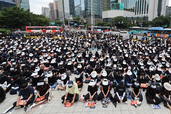 서울 서초구의 한 초등학교에서 발생한 교사 사망 사건과 관련해 22일 오후 서울 종로구 보신각 인근에서 열린 추모식에서 참가자들이 묵념하고 있다.
