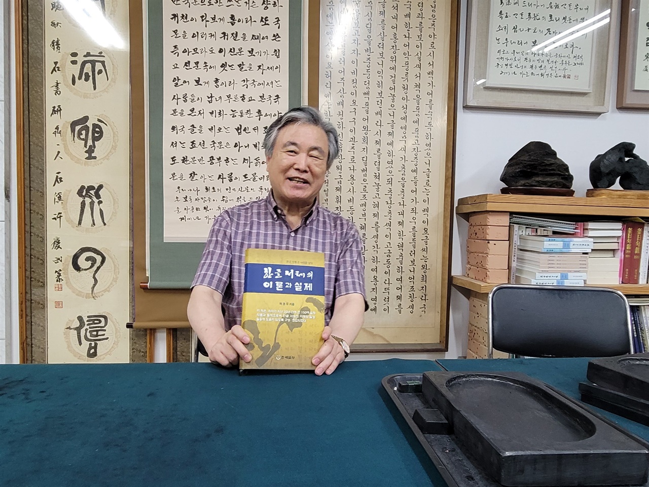 부산광역시에 있는 한국서체연구회 사무실에서 자신이 쓴 이론서를 들어 보이는 허경무 이사장  