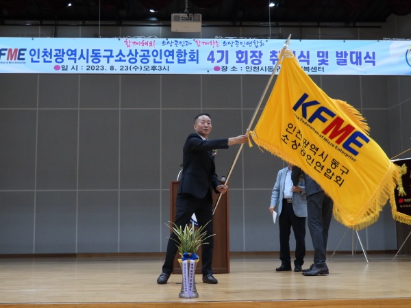 '인천시 동구소상공인연합회 제4기 회장 취임식 및 발대식'에서 유병우 회장이 협회기를 흔들어 보이고 있다.