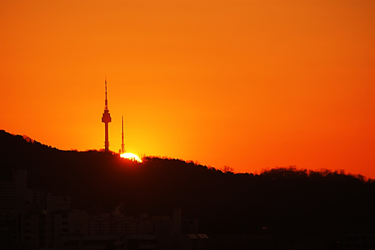 남산 타워 아래에서 동짓날 태양이 솟아 오르고 있다. 07:48