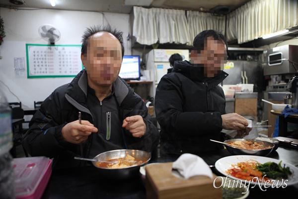 서울 강남구 대치동 선경아파트에서 일하다 해고된 경비원들이 지난 11일 피켓 시위를 마치고 인근 지하 상가 식당에서 식사하고 있다. 24시간 근무를 마친 뒤 아침 6시에 교대하고 퇴근하면 종종 함께 찾던 식당이라고 했다. 