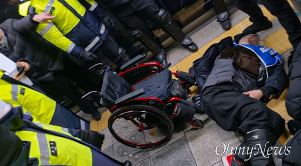 경찰이 강제 퇴거시키는 도중 박경석 전장연 공동대표가 휠체어에서 떨어졌다.