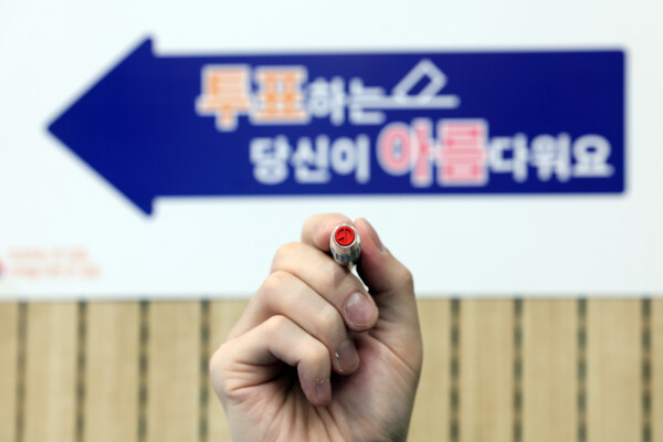 제22대 국회의원선거를 하루 앞둔 9일 오후 서울 영등포구 YDP미래평생학습관에 마련된 투표소에서 관계자가 기표용구를 들어보이고 있다.