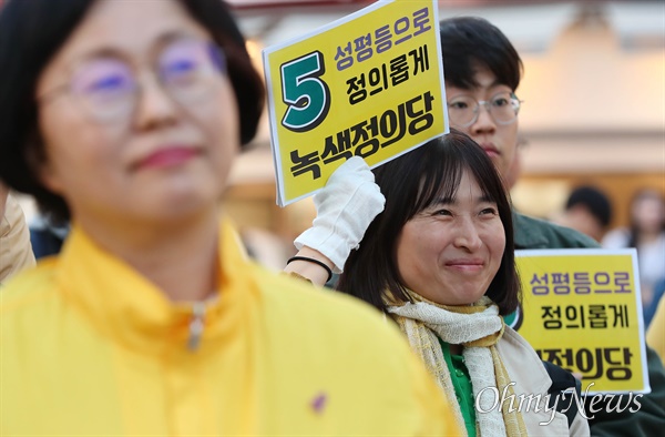 제22대 국회의원 선거를 하루 앞둔 9일 오후 서울 마포구 홍대 상상마당 앞에서 열린 녹색정의당 장혜영 서울 마포구을 국회의원 후보 마무리 유세에서 당원들이 유세를 보고 있다.