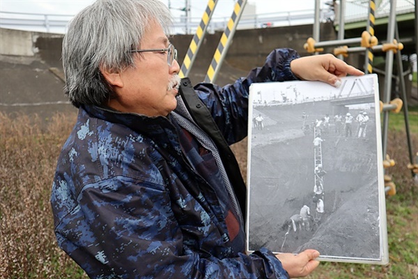관동대지진 당시 학살당한 조선인 유골 발굴 사진을 들고있는 니시자키씨 모습. 