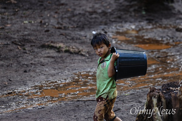 내전 중인 미얀마의 카레니 주에서 한 어린이가 물통을 들고 걷고 있다. 난민촌에서 가장 힘든 일은 물을 마시는 것이다. 2023년 촬영.