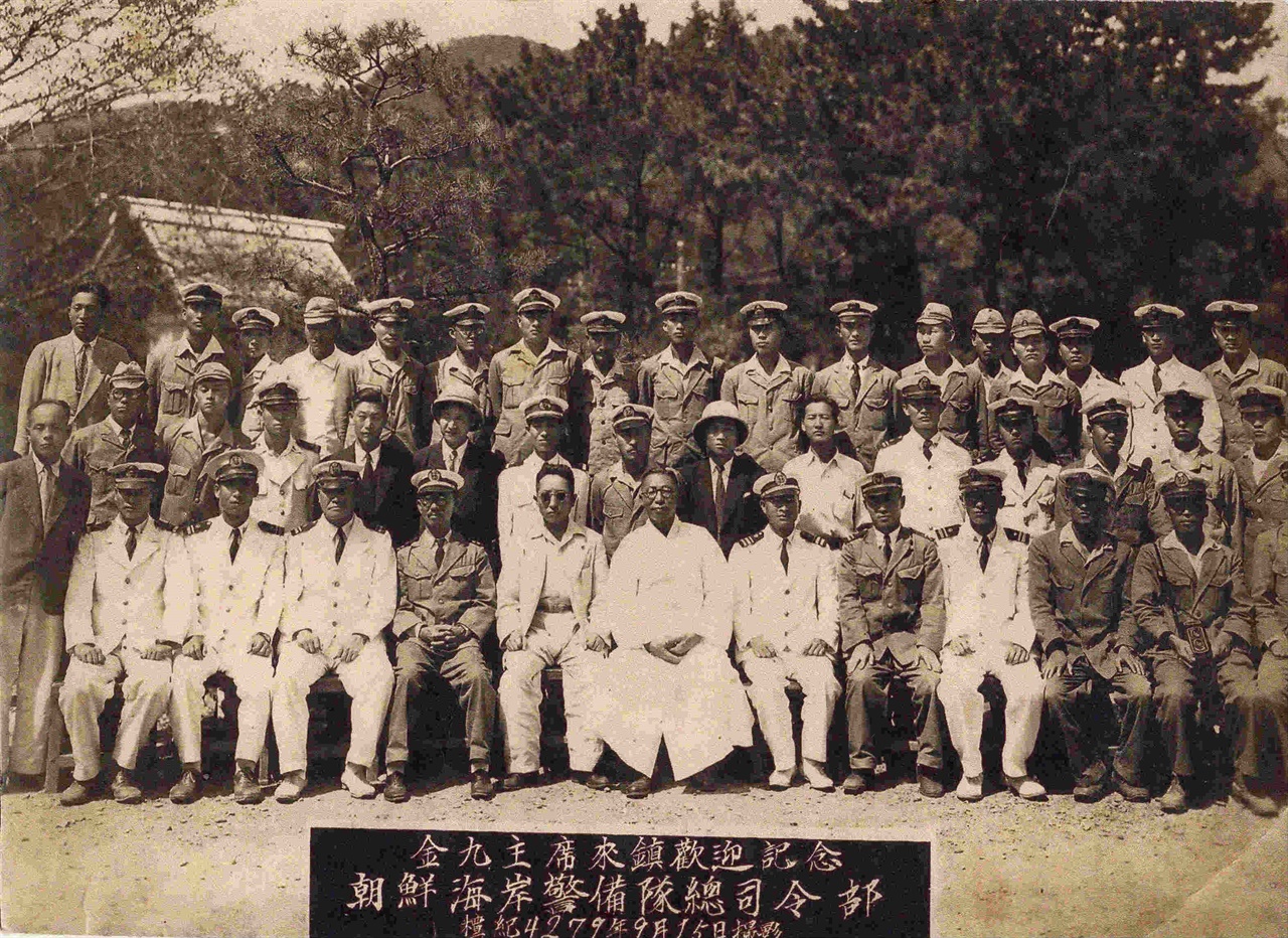  1946년(사진 설명에는 단기 4279년) 9월 15일 조선해안경비대 진해 기지를 방문한 김구 선생과 경비대 간부들. 맨 뒷줄 오른쪽에서 두번째 흰 제복을 입은 이가 이상규 중위(당시 계급).