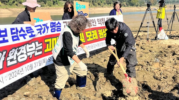  고마나루에서 삽으로 펄을 담는 보철거시민행동.